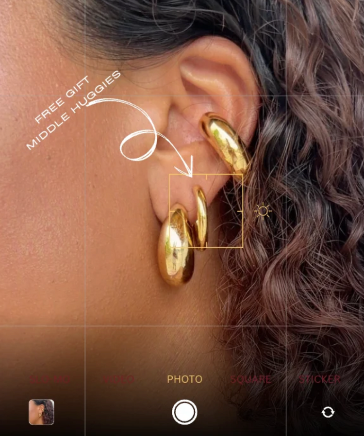 Gold plated huggies on an ear, with the middle huggie marked as the free launch gift